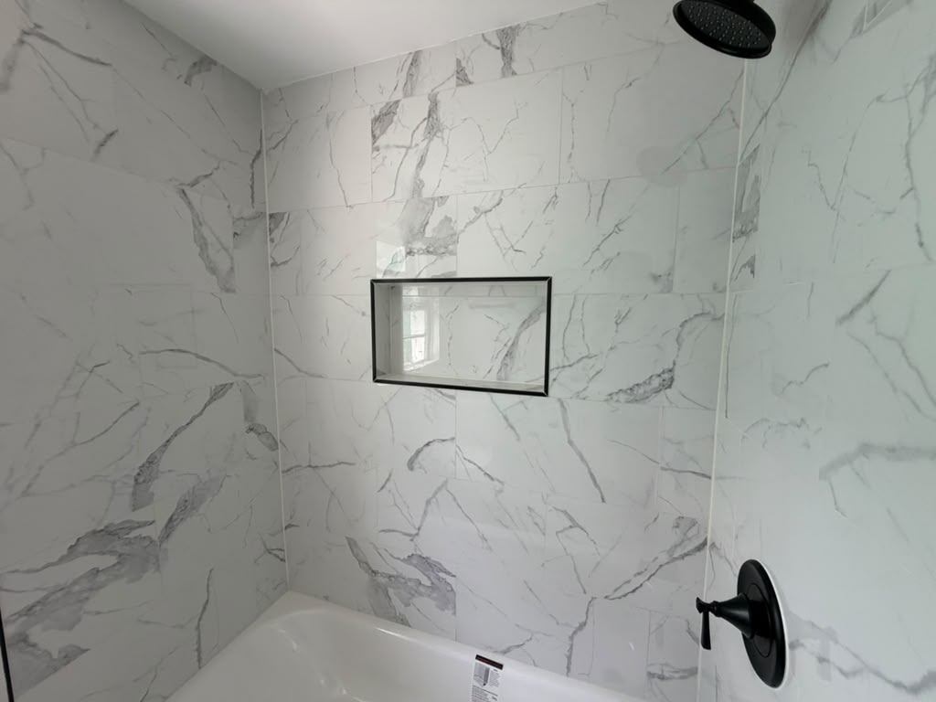 Tile shower surround with framed niche and rainfall shower head