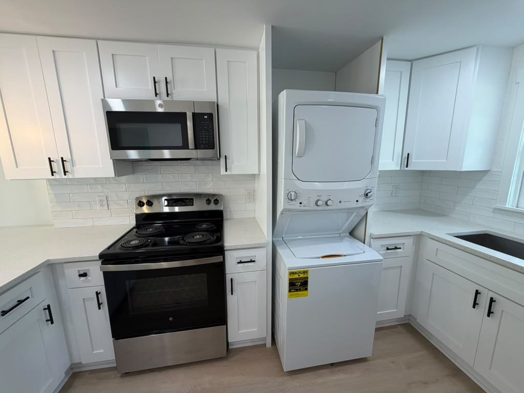 Kitchen corner with stacked washer and dryer built into cabinetry