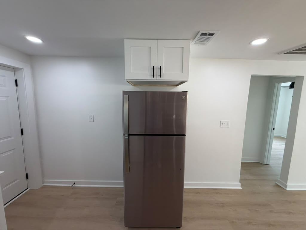 Refrigerator alcove with new upper cabinet and recessed lighting