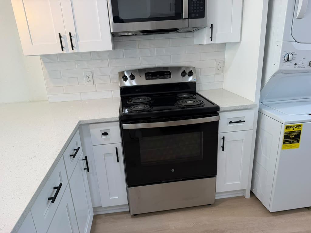 New range, quartz countertop and subway tile backsplash