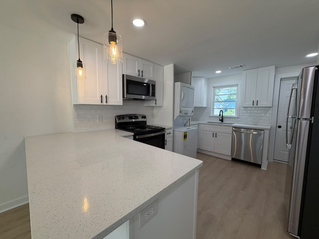 Cottage kitchen in Savannah after a full interior renovation with white shaker cabinets and quartz counters