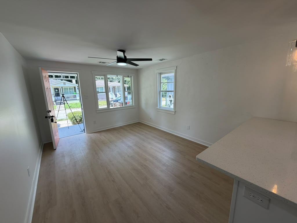 Living room entry with natural light and new flooring throughout